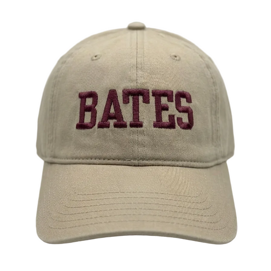 Beige cap with 'BATES' embroidered on a white background