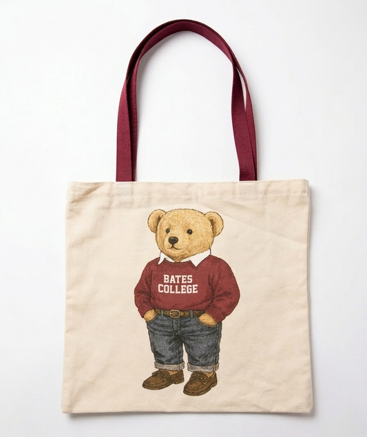 Tote bag with teddy bear design wearing a 'Bates College' sweater on a white background