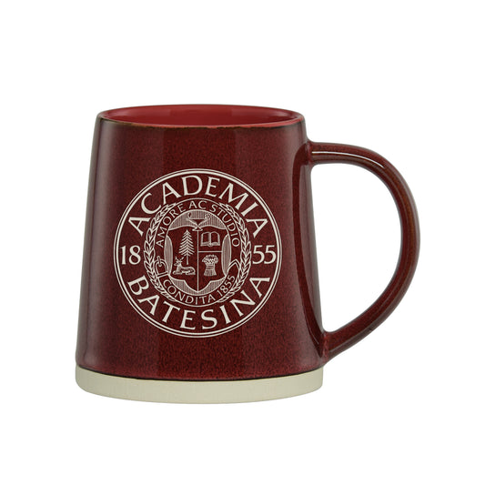 Red mug with Bates seal on a white background