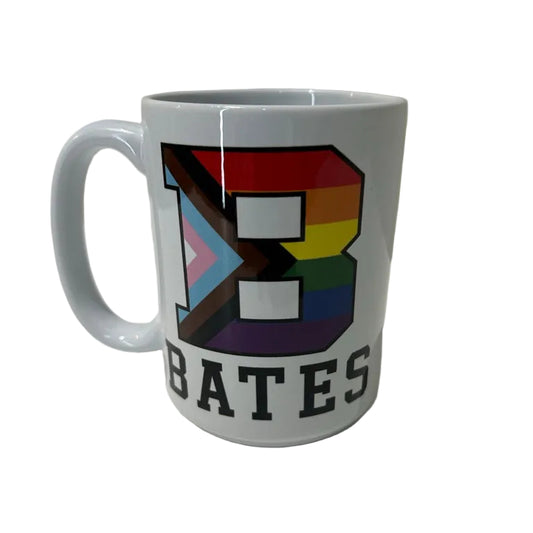 White mug with rainbow design and 'BATES' text on a white surface