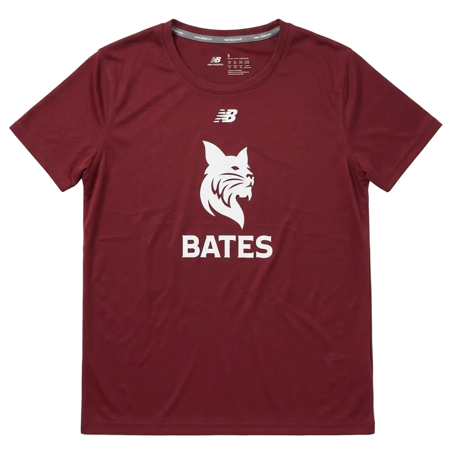 A maroon short-sleeve athletic t-shirt by New Balance, featuring a white bobcat graphic and the name 'BATES' printed on the front, laid flat against a light gray background.